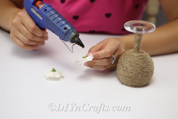 Glue your faux flowers to your candle holder.