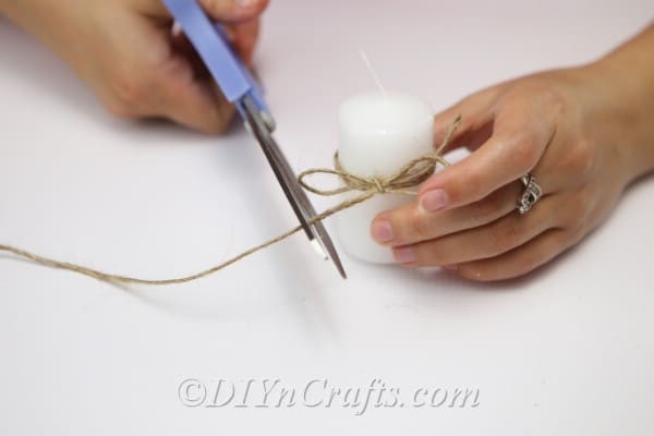 Cut the twine after tying the bow around the candle.