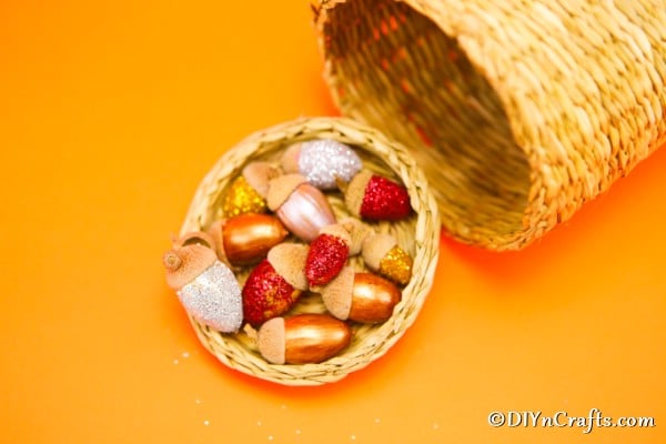glitter acorns harvest craft displayed in a cornucopia basket