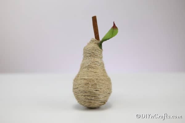 A finalized twine wrapped pear fruit decoration