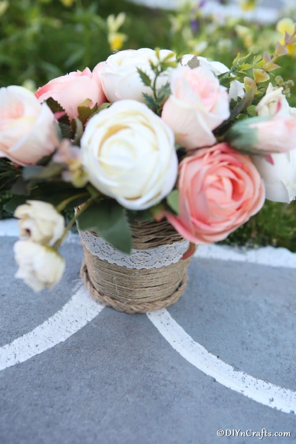 Finished woven basket sitting on a concrete driveway