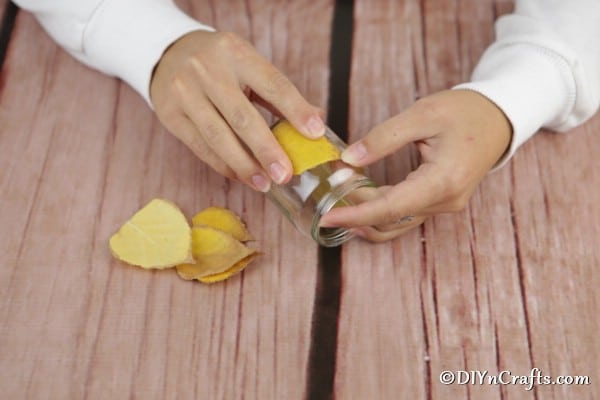 Attaching leaf to a candle lanterns craft