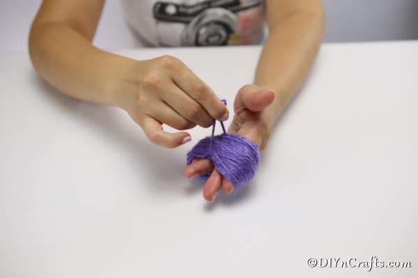 Clipping the yarn and cutting to create a yarn flower