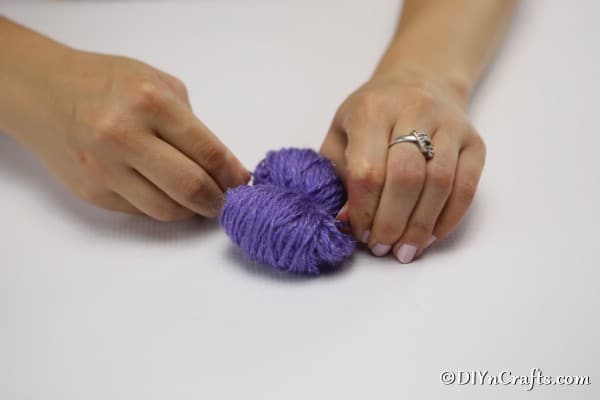 Tying the yarn flower in the middle with more yarn