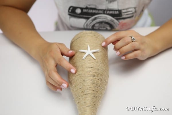 Adding starfish to the twine wrapped bottle