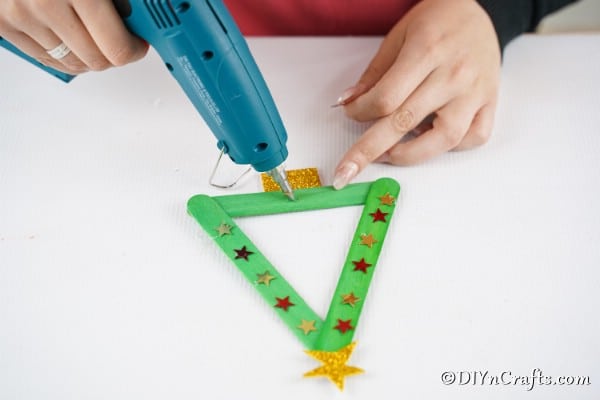 Decorating the popsicle stick Christmas tree