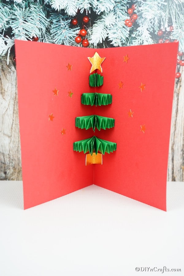 A 3D Christmas tree card displayed on a white shelf