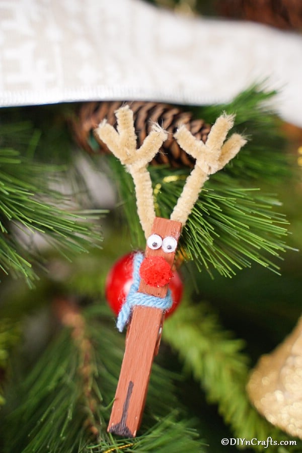 The clothespin reindeer ornaments on display in a Christmas tree