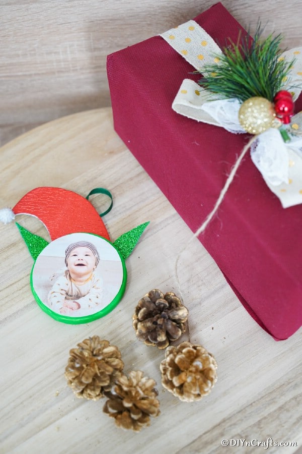 Elf on the Shelf Ornament on a wooden table with holiday decor