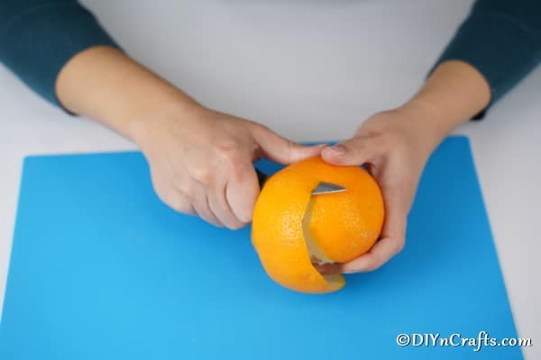 Peeling an orange to make a star garland