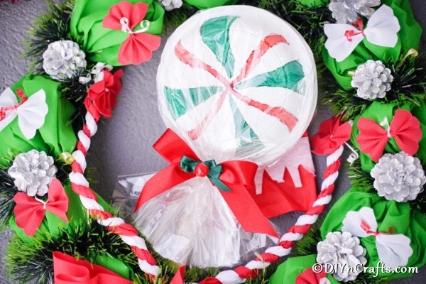 Lollipop ornament decoration laying among other holiday decor