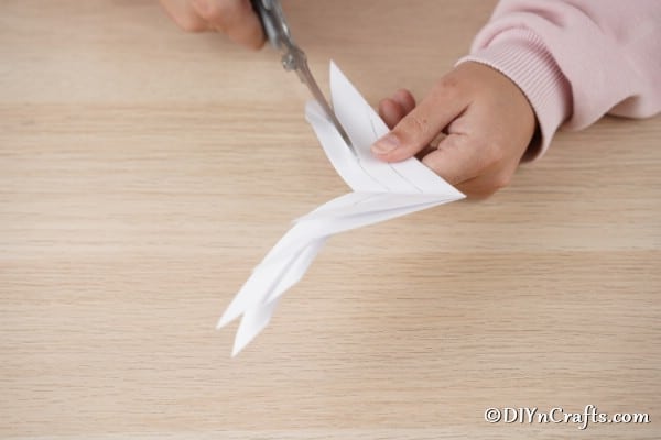 Slicing paper into a star shape for 3d snowflake or star for an ornament
