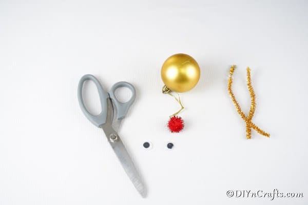 Supplies for making a reindeer Christmas ball ornament