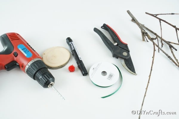 Supplies needed to make a wood slice reindeer ornament