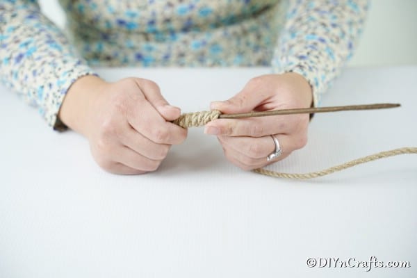 Attaching rustic twine around the candy cane ornament wire
