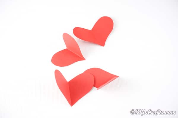 Cutting hearts out of red craft paper