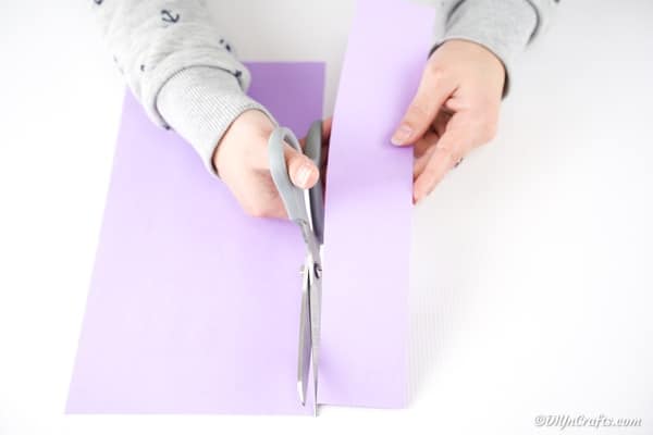 Cutting strip of paper out of page of paper