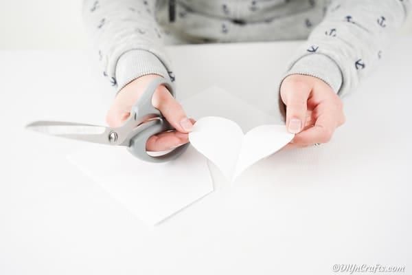 Cutting out a heart from paper