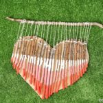 Wooden heart decoration on green grass
