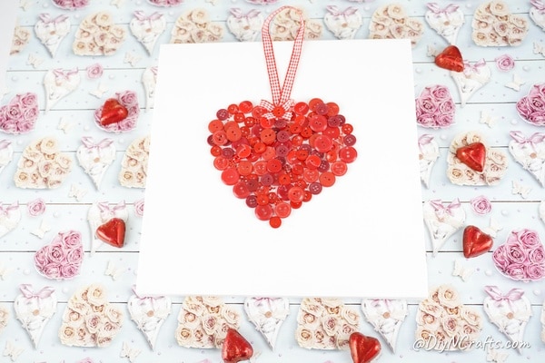 Toile de coeur de bouton sur une table en papier de la Saint-Valentin