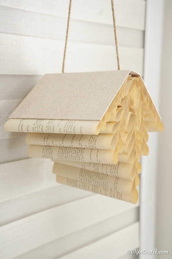 Rolled paper book decoration against siding wall