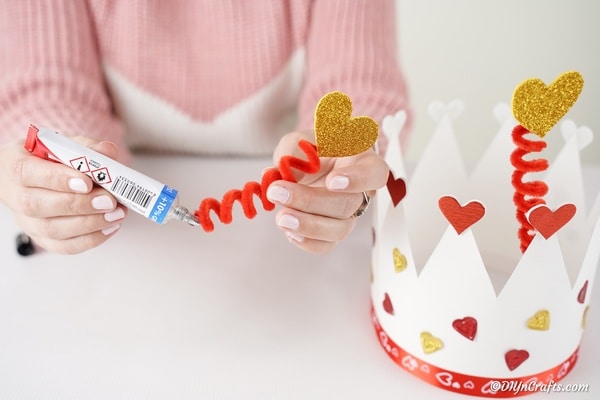 Gluing pipe cleaners inside paper crown
