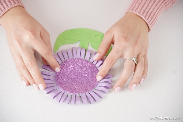 Placing the purple foam paper onto middle of paper flower