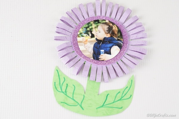 Paper flower photo card on white sruface