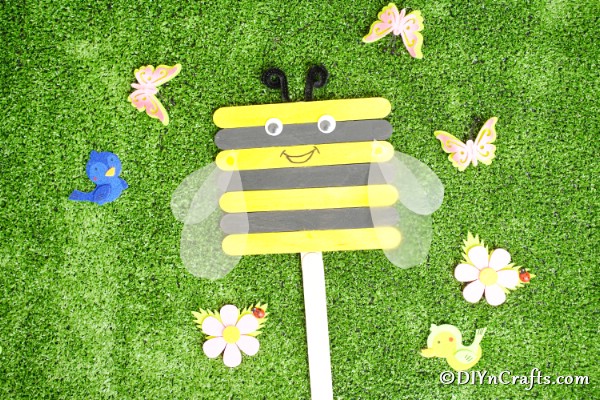Craft stick bee on grass