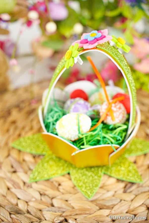 Glitter Easter egg basket on woven mat