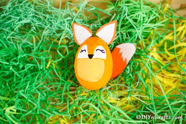 Easter egg fox decoration in fake green grass