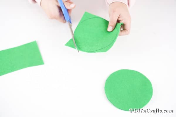 Cutting out green circles of paper