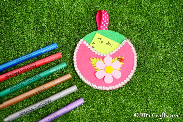 Pocket wall organizer on grass with markers