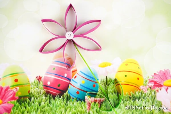 Paper flower laying on Easter background