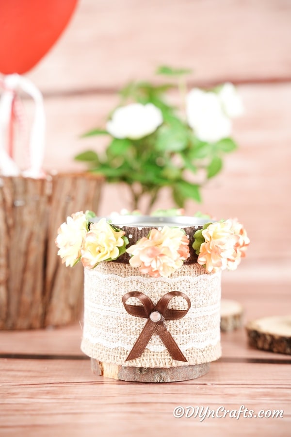 Small decorative storage can in front of a wooden stump