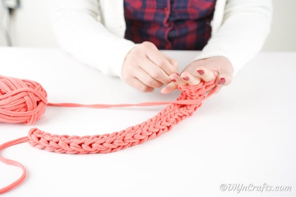 Finger knitting pink yarn