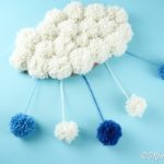 Cloud pom pom craft on blue surface