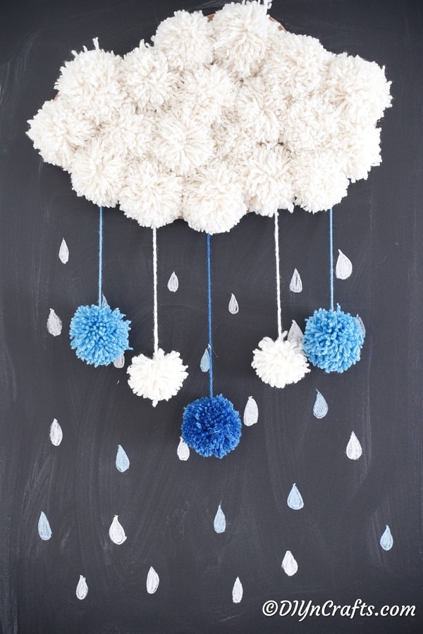 Yarn pom pom cloud on chalkboard