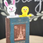Easter bookmarks in book in front of chalkboard