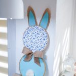 Bunny wall art leaning against wall on table