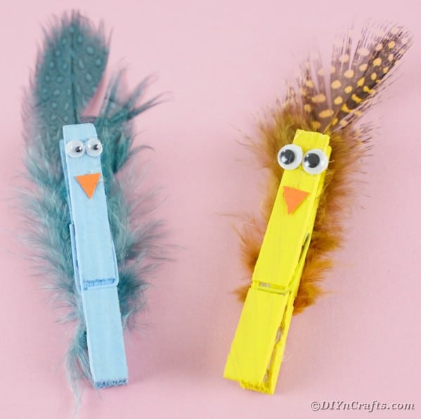 Clothespin birds against pink background
