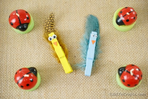 Clothespin birds on burlap with ladybugs
