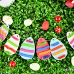 Paper egg garland laying on grass