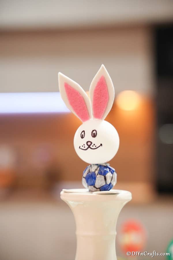 Lollipop Easter bunny sitting on top of white stand