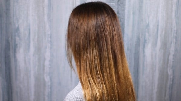 Brushing long brunette hair