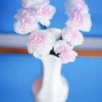 Tissue paper flowers in white face with blue background