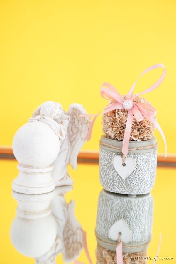 Flower ball on jar with yellow background