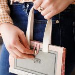 Woman in jeans holding old book purse