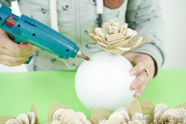 Gluing paper flowers to styrofoam ball