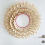 Upcycled book page wreath hanging on door